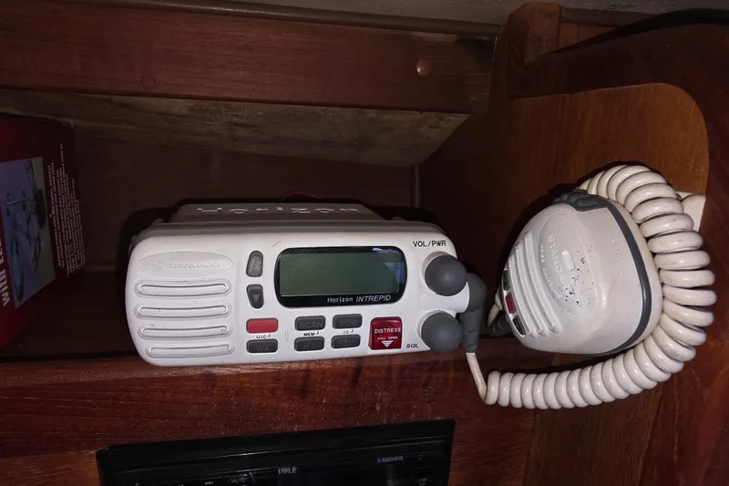 Slide: The Image of Marine radio equipment on a 1970 Newport 41 sailboat, featuring a Standard Horizon Intrepid model. - 10