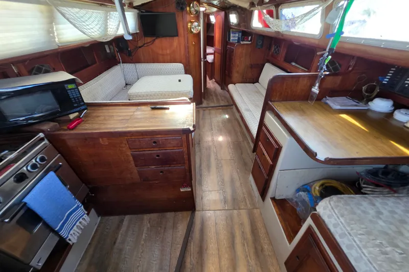 Slide: The Image of Interior of a 1970 Newport 41 sailboat with wood finishes and cozy seating. - 1
