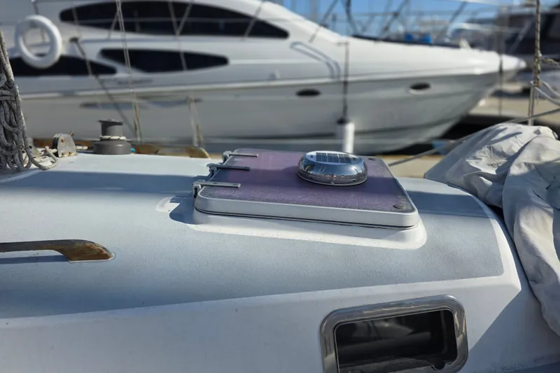 Slide: The Image of Close-up of a 1970 Newport 41 yacht deck with solar panel and hatch. - 21