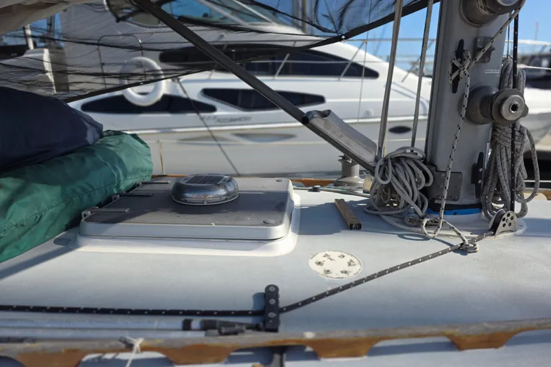 Slide: The Image of 1970 Newport 41 sailboat deck with rigging and hatch, docked in marina. - 22
