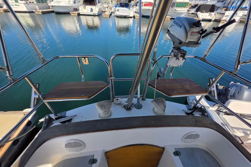 Slide: The Image of 1970 Newport 41 sailboat stern view with motor, docked at marina. - 24
