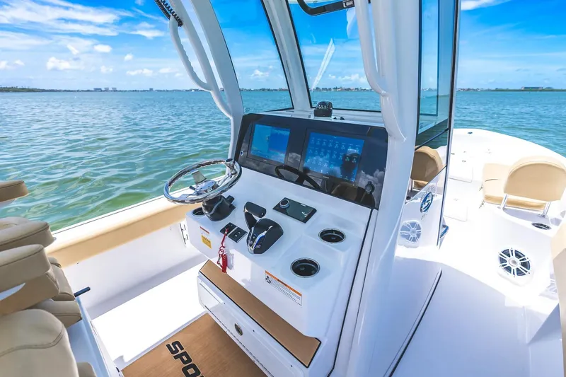 Slide: The Image of 2026 Sportsman Masters 267OE Bay Boat interior with modern dashboard and ocean view. - 7