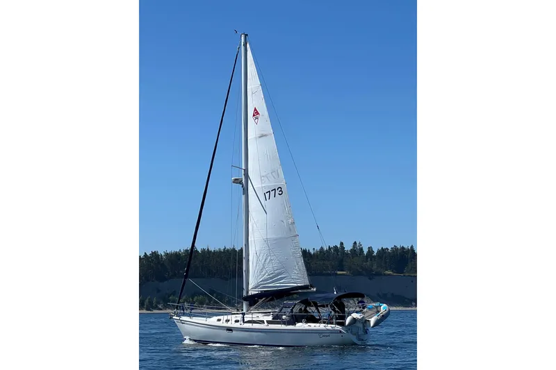 Slide: The Image of 2007 Catalina 34 MkII sailboat on calm water under clear blue sky. - 2