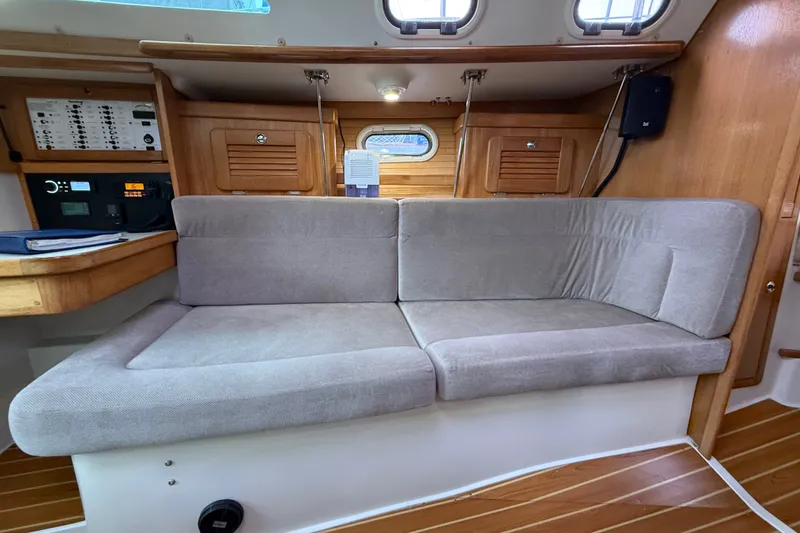Slide: The Image of Interior of a 2007 Catalina 34 MkII sailboat with cushioned seating and wooden accents. - 54