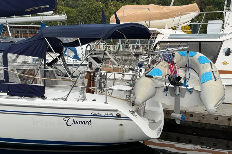 Slide: The Image of 2007 Catalina 34 MkII sailboat docked with inflatable dinghy attached. - 31