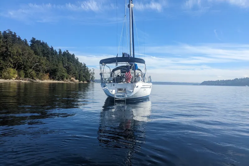 Slide: The Image of Sailboat Catalina 34 MkII (2007) anchored on calm water near forested shoreline. - 1