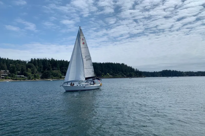 Slide: The Image of Sailboat Catalina 34 MkII 2007 cruising on a serene lake under a partly cloudy sky. - 3