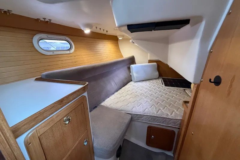 Slide: The Image of Cozy cabin interior of 2007 Catalina 34 MkII sailboat with bed and wooden cabinetry. - 63