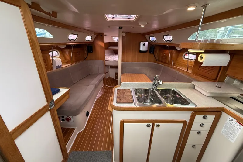 Slide: The Image of Interior of 2007 Catalina 34 MkII sailboat with cozy seating and compact kitchen area. - 47