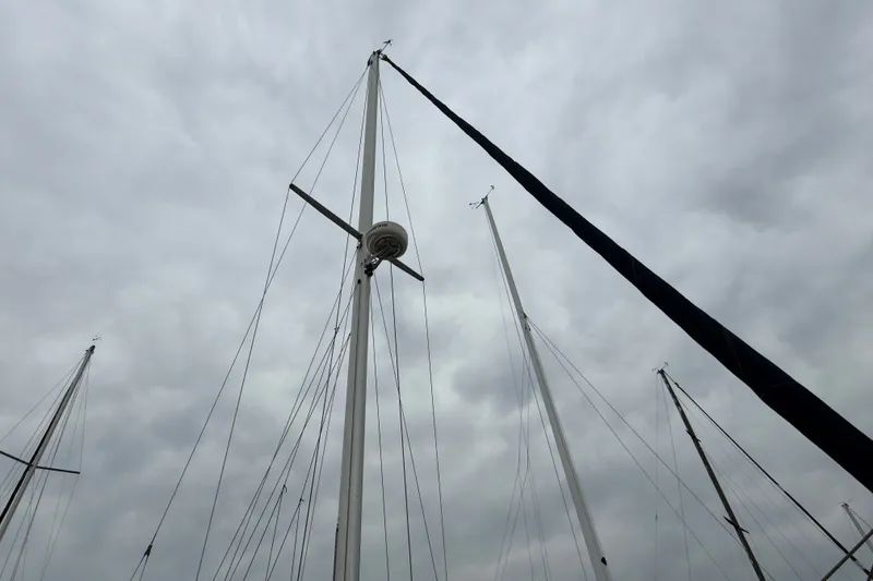 Slide: The Image of Masts of a 2007 Catalina 34 MkII sailboat against a cloudy sky. - 16