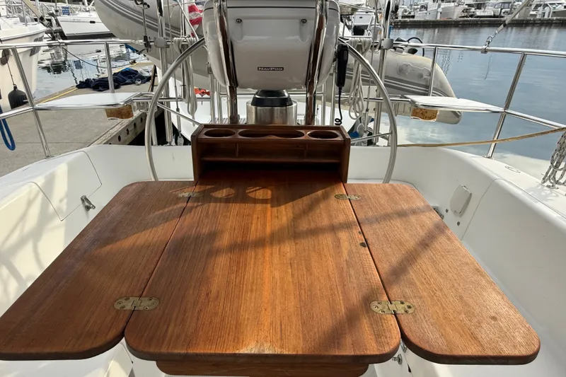 Slide: The Image of Cockpit of 2007 Catalina 34 MkII sailboat with wooden table and steering wheel. - 44
