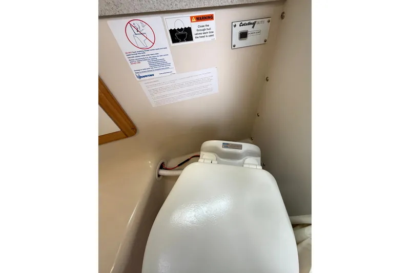 Slide: The Image of Catalina 34 MkII 2007 boat toilet with warning labels and control panel. - 68