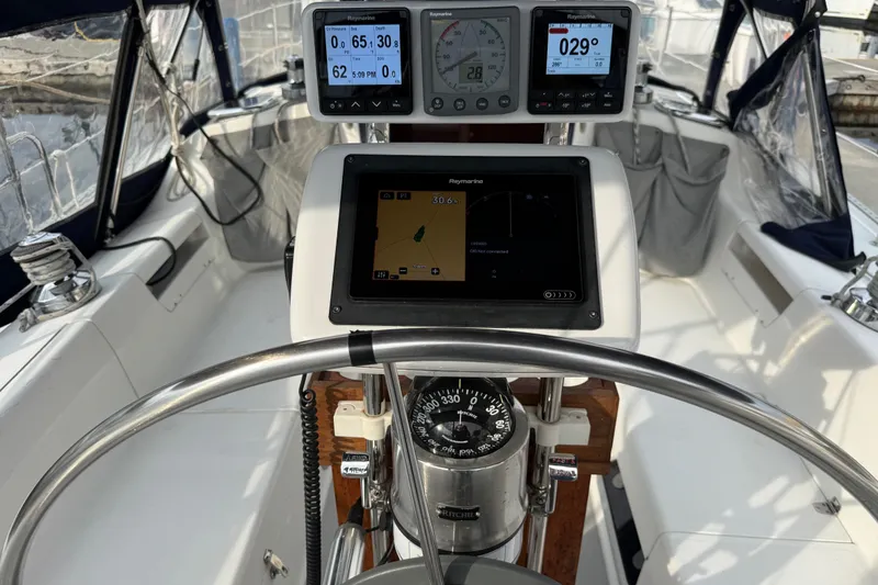 Slide: The Image of Cockpit of 2007 Catalina 34 MkII sailboat with navigation instruments and steering wheel. - 33
