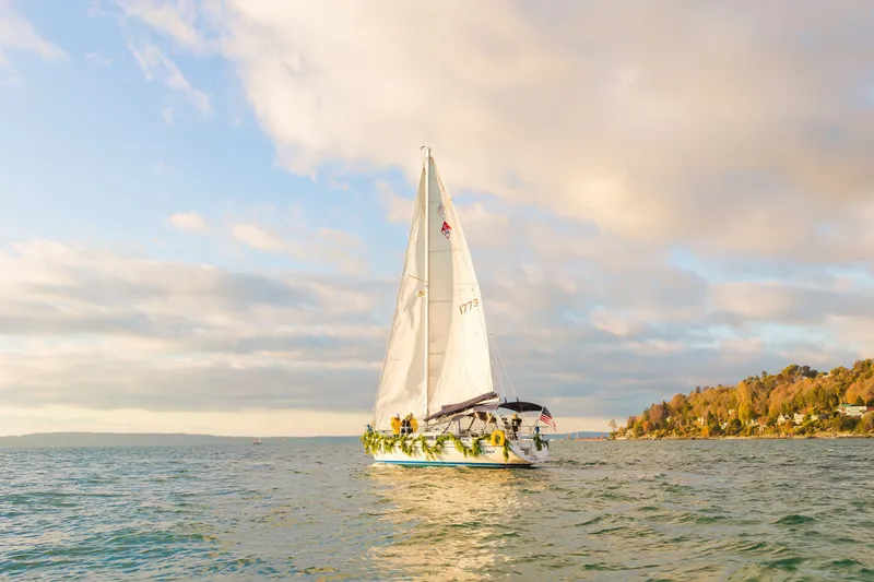 Slide: The Image of Sailboat Catalina 34 MkII 2007 cruising on a scenic lake under a cloudy sky. - 12