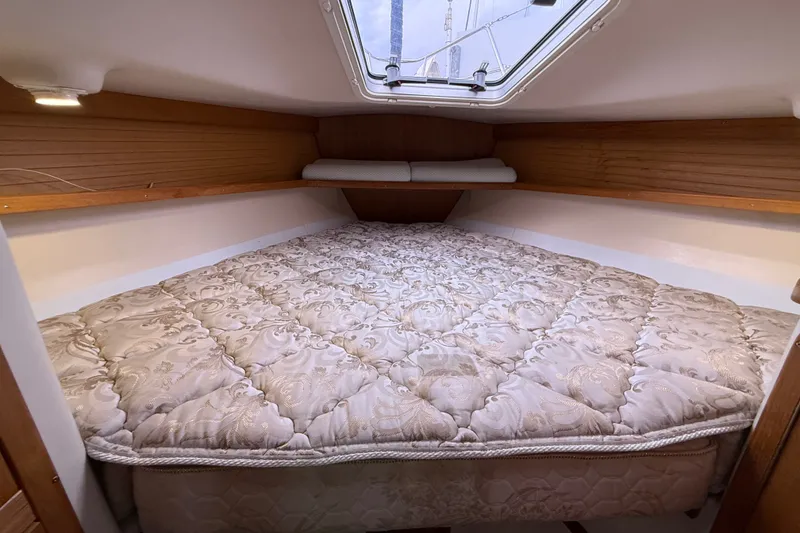 Slide: The Image of Cozy cabin interior of 2007 Catalina 34 MkII sailboat with patterned bedding. - 58
