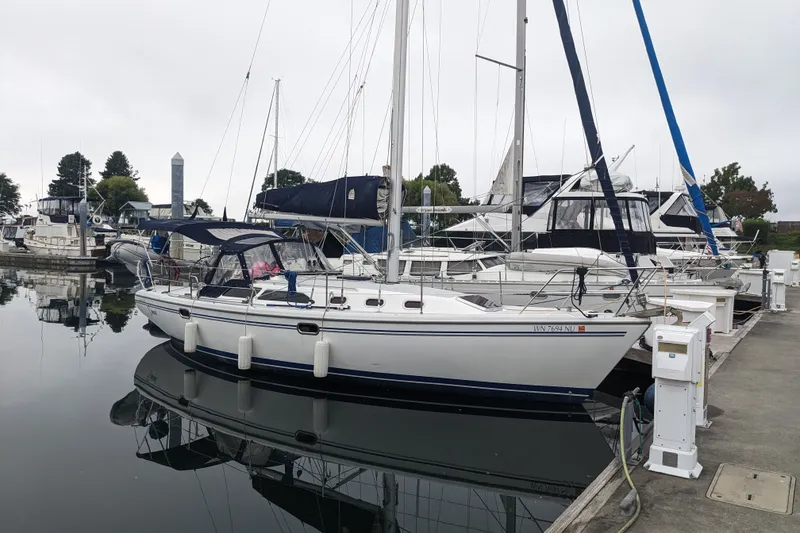 Slide: The Image of 2007 Catalina 34 MkII sailboat docked at a marina, surrounded by other boats. - 11