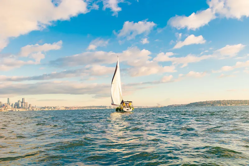 Slide: The Image of Sailboat Catalina 34 MkII 2007 on open water with city skyline and blue sky. - 13