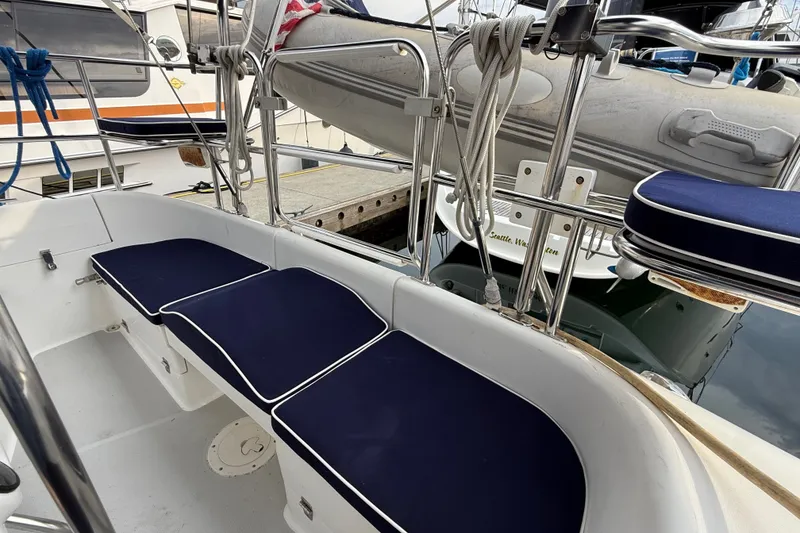 Slide: The Image of Cockpit of 2007 Catalina 34 MkII sailboat with blue cushions and docked dinghy. - 35