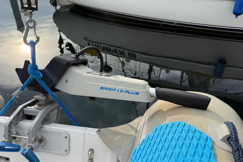 Slide: The Image of Electric outboard motor on a 2007 Catalina 34 MkII sailboat, docked in calm waters. - 32