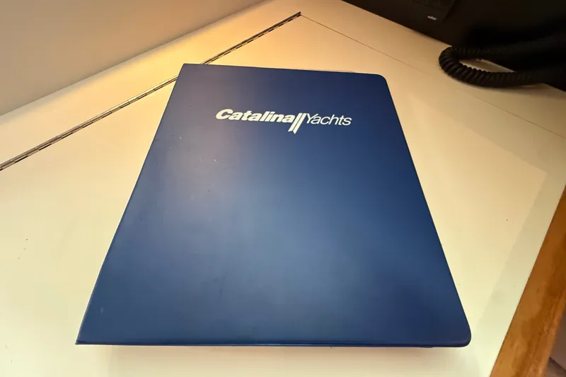 Slide: The Image of Blue Catalina Yachts folder on desk, related to 2007 Catalina 34 MkII model. - 51
