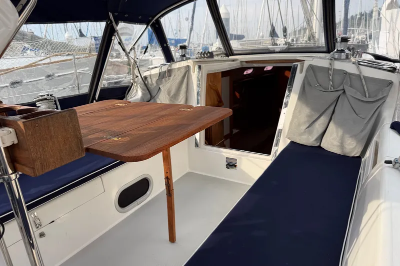 Slide: The Image of 2007 Catalina 34 MkII sailboat cockpit with wooden table and navy seating. - 42