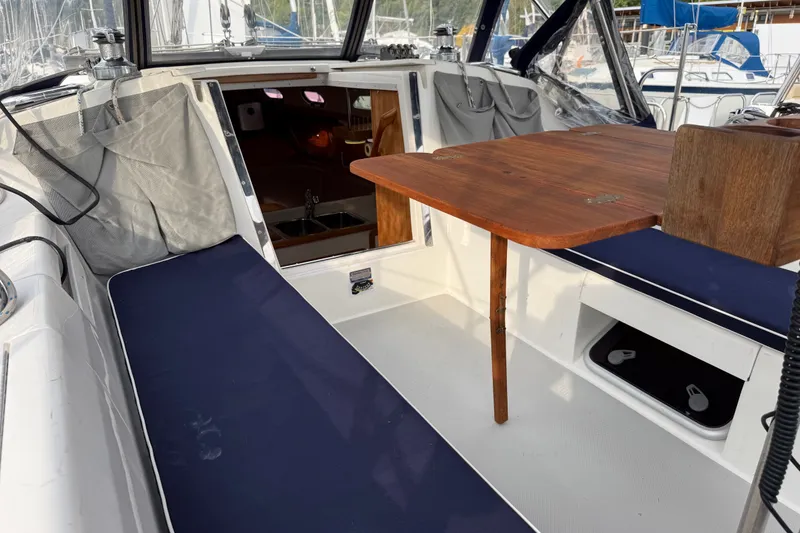 Slide: The Image of Cockpit of 2007 Catalina 34 MkII sailboat with wooden table and navy cushions. - 43