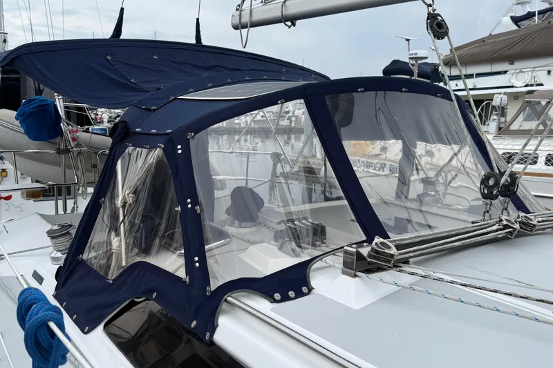 Slide: The Image of 2007 Catalina 34 MkII sailboat with blue canvas dodger in marina setting. - 26