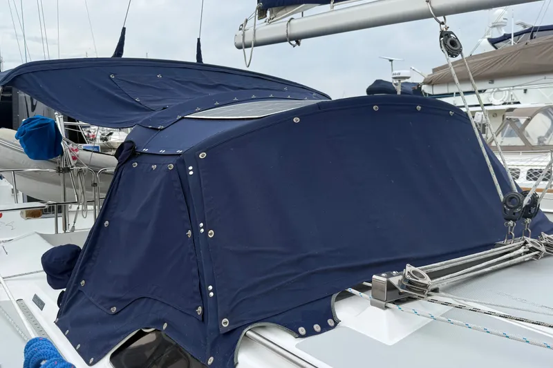 Slide: The Image of 2007 Catalina 34 MkII sailboat with blue canvas cover in marina. - 19