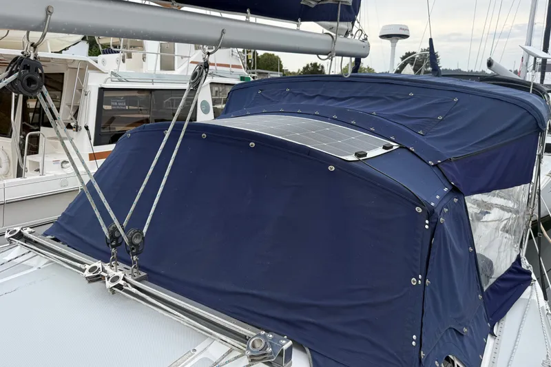 Slide: The Image of 2007 Catalina 34 MkII sailboat with blue canvas cover and solar panel. - 25