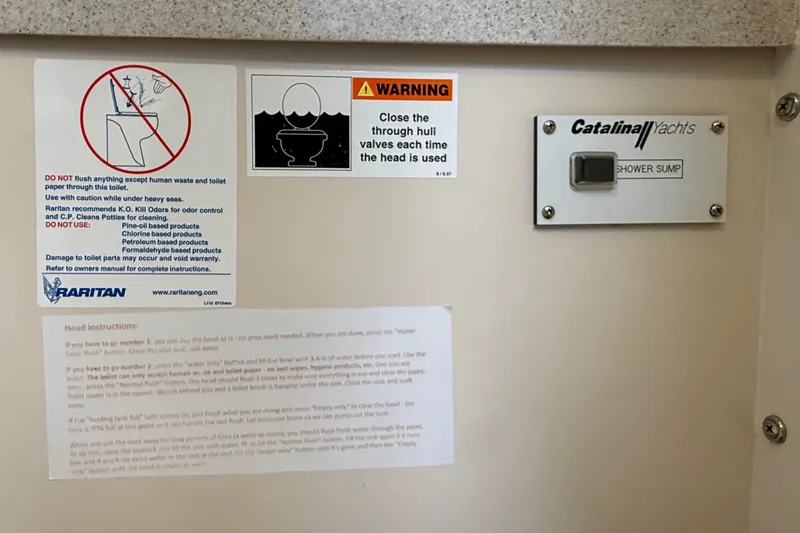 Slide: The Image of Warning signs and instructions inside a 2007 Catalina 34 MkII yacht bathroom. - 69
