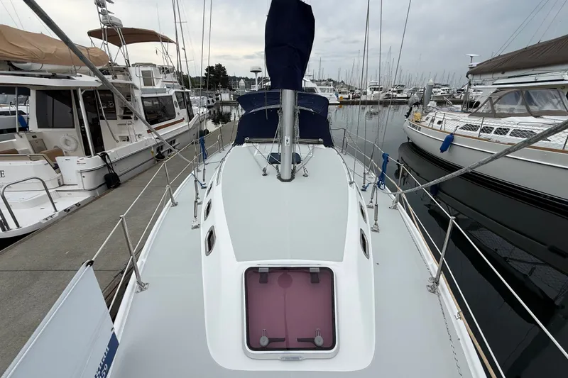 Slide: The Image of 2007 Catalina 34 MkII sailboat docked at marina, surrounded by other boats. - 24