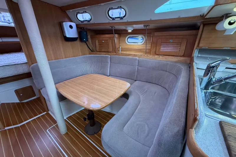 Slide: The Image of Interior of 2007 Catalina 34 MkII sailboat with cozy dining area and wooden finishes. - 55