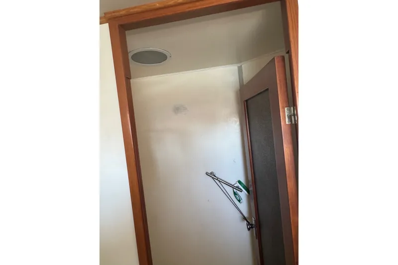 Slide: The Image of Shower area inside a 1989 DeFever 54 yacht, featuring wooden trim and a glass door. - 42