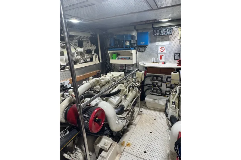 Slide: The Image of Engine room of a 1989 DeFever 54 yacht, featuring dual engines and control panels. - 45