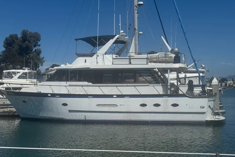 Slide: The Image of 1989 DeFever 54 yacht docked at marina under clear blue sky. - 57
