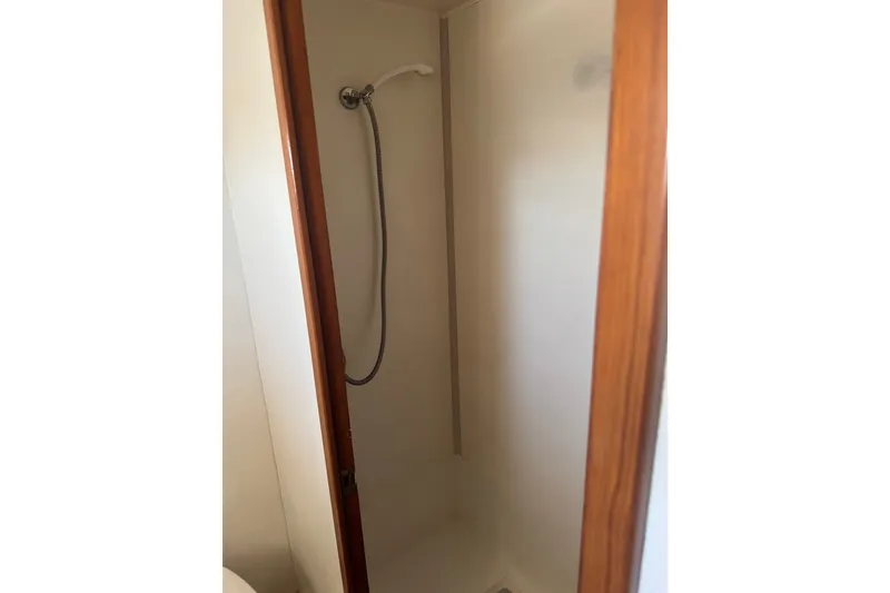 Slide: The Image of Shower area inside a 1989 DeFever 54 yacht, featuring a handheld showerhead. - 41
