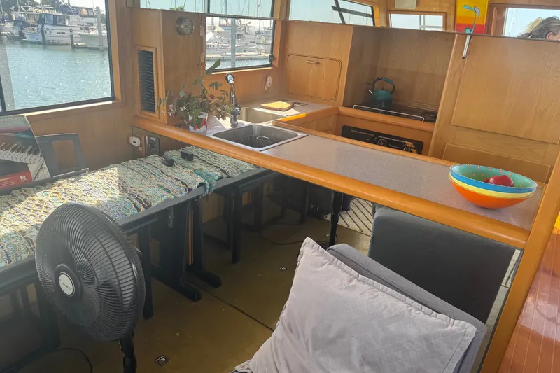 Slide: The Image of Interior of 1989 DeFever 54 yacht with kitchen, fan, and colorful bowl. - 32
