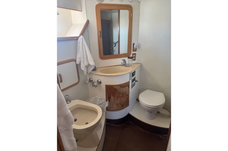 Slide: The Image of Bathroom interior of 1989 DeFever 54 yacht with sink, toilet, and mirror. - 40