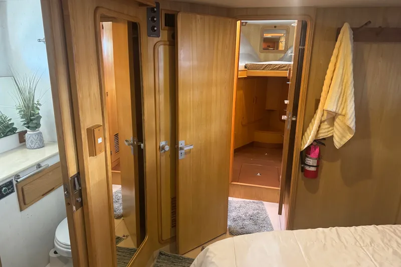 Slide: The Image of Interior of 1989 DeFever 54 yacht with wooden doors, mirror, and cozy cabin. - 19