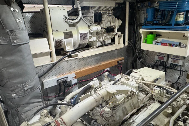 Slide: The Image of Engine room of a 1989 DeFever 54 yacht, showcasing machinery and equipment. - 47