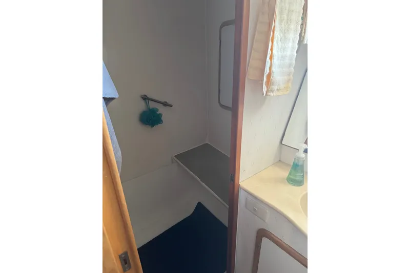 Slide: The Image of Bathroom interior of 1989 DeFever 54 yacht, featuring shower and sink area. - 27