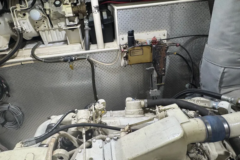 Slide: The Image of Engine room of a 1989 DeFever 54 yacht, showcasing mechanical components and wiring. - 51