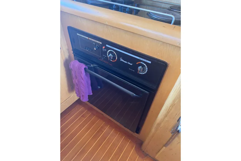 Slide: The Image of Magic Chef oven in a 1989 DeFever 54 yacht kitchen with wooden flooring. - 18