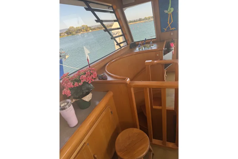Slide: The Image of Interior of 1989 DeFever 54 yacht with wooden finishes and floral decor. - 16