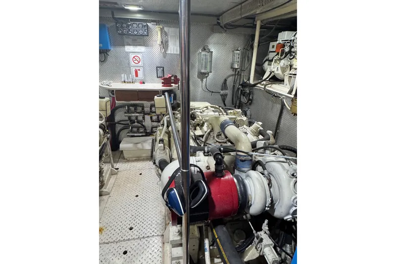 Slide: The Image of Engine room of a 1989 DeFever 54 yacht, showcasing mechanical components and equipment. - 44