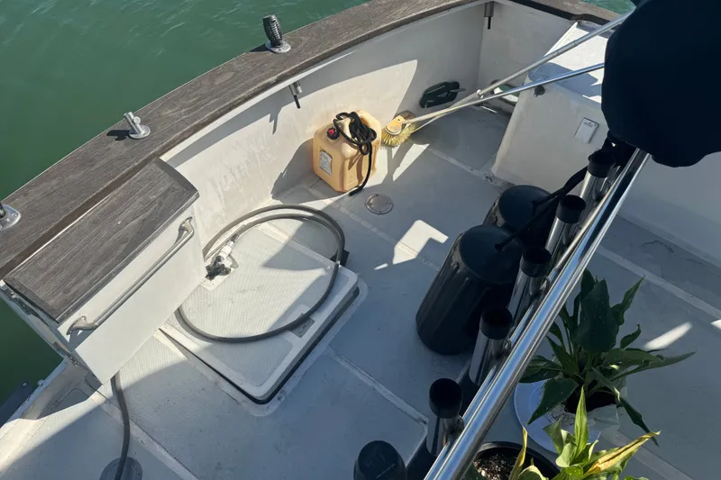 Slide: The Image of 1989 DeFever 54 boat deck with cleaning supplies and plants. - 37