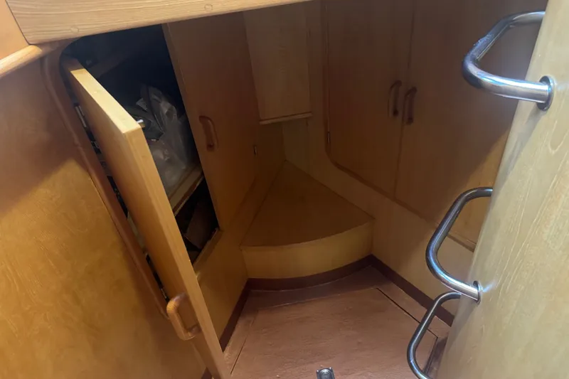 Slide: The Image of Interior of 1989 DeFever 54 yacht showing wooden cabinetry and storage space. - 30