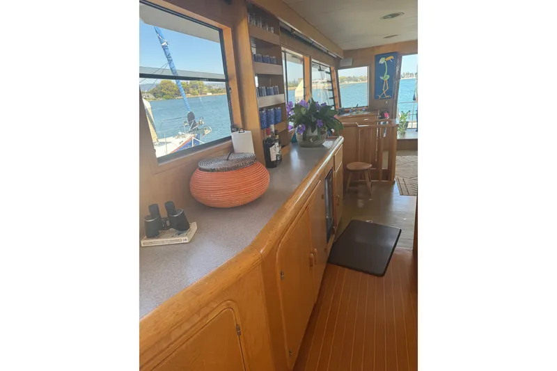 Slide: The Image of Interior of 1989 DeFever 54 yacht with wooden cabinetry and waterfront view. - 22