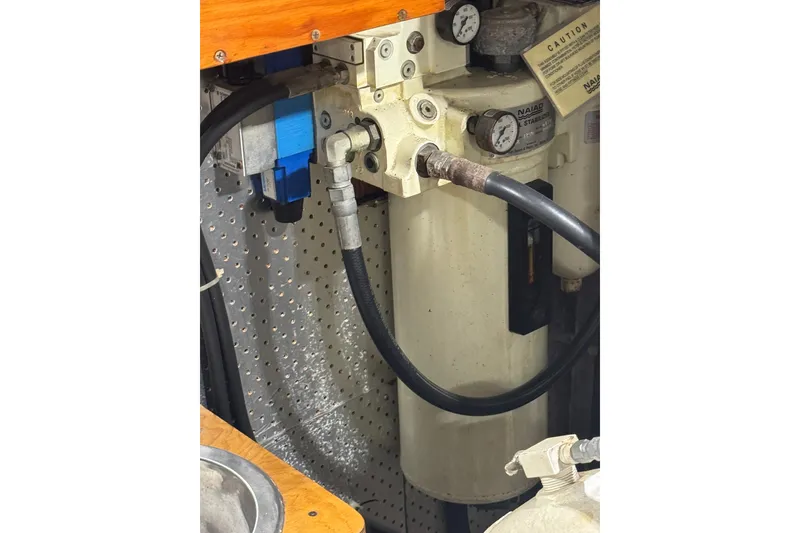 Slide: The Image of Hydraulic system components on a 1989 DeFever 54 yacht, featuring gauges and hoses. - 54