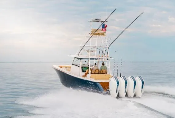 Slide: The Image of 2026 Phenom 43 Center Console boat cruising on open water with multiple outboard engines. - 1
